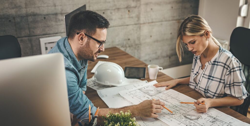 Contractor and architect internally reviewing plans for clients design build project