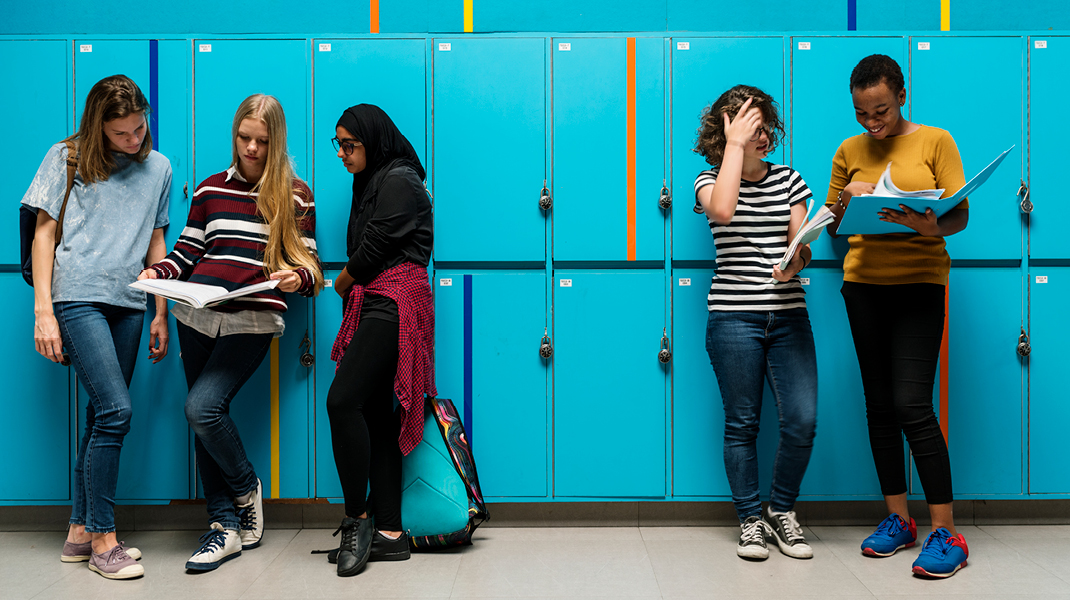 high school students standing by lockers